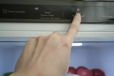 Palec wskazuje na panel sterowania lodówki no frost, gdzie widoczna jest temperatura 3°C dla chłodziarki.